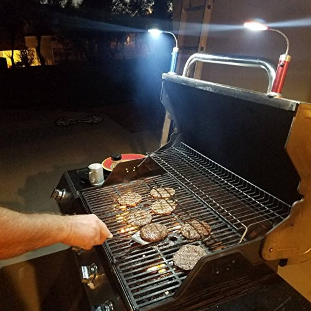 Magnetic LED COB light set lighting a grill at night near a barbecue setup