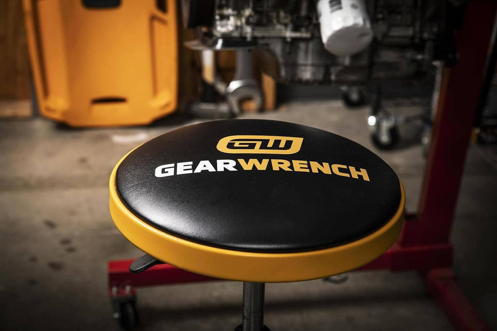 GEARWRENCH shop stool seat with black cushion and orange edge, height-adjustable column