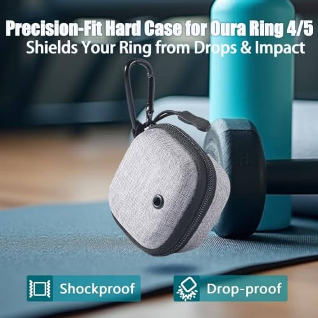 Grey hard-shell pouch with carabiner on table, positioned upright as protective case