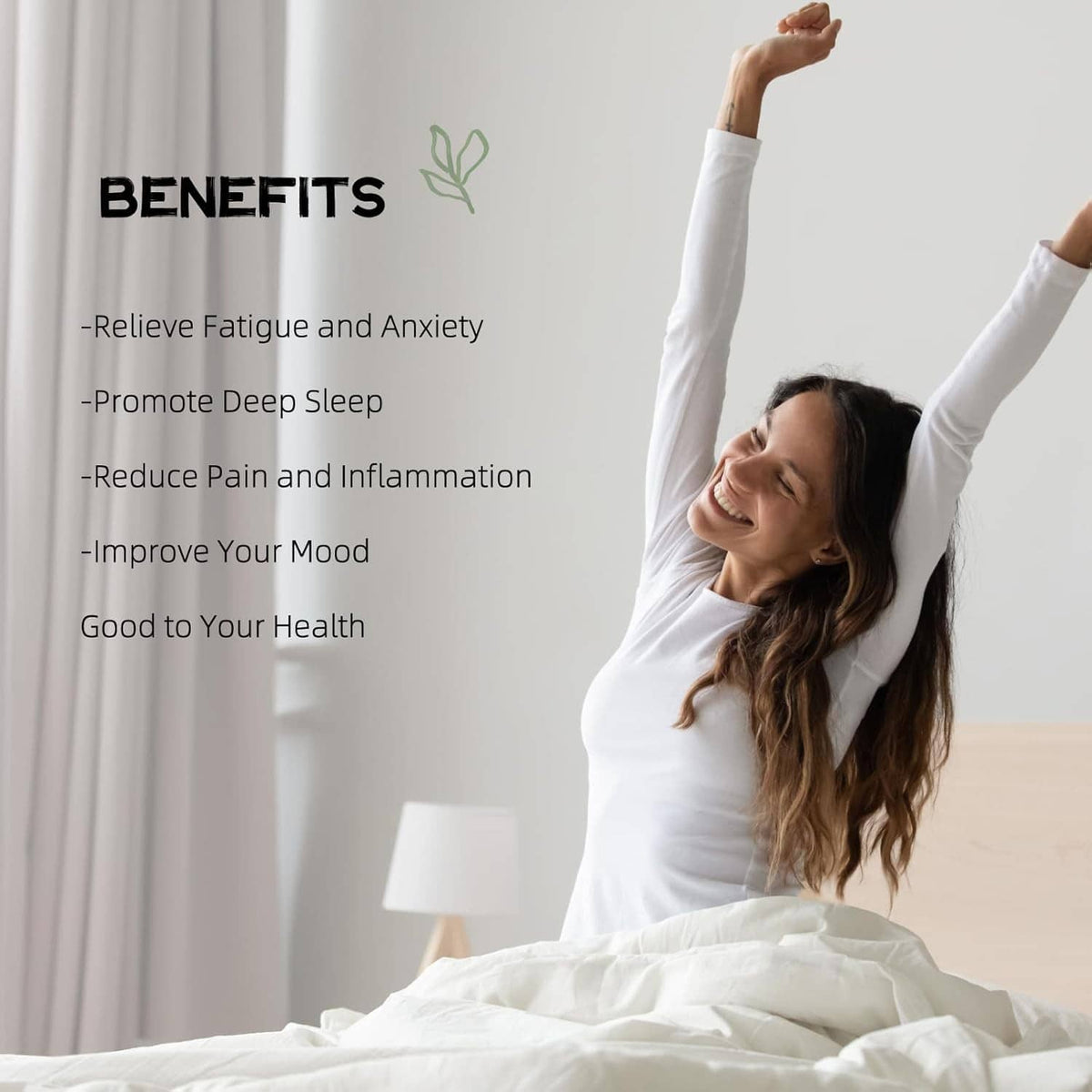 Dark grounding mattress pad on bed with white bedding and person stretching