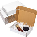 White corrugated shipping box set, open with brown lid and packing items inside