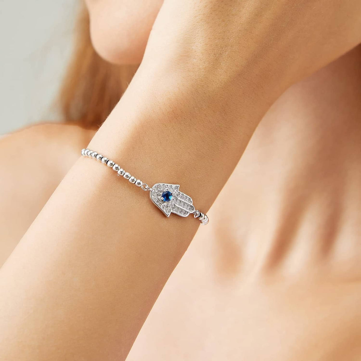 IVY TAILI silver Hamsa bracelet with blue stone and beaded chain