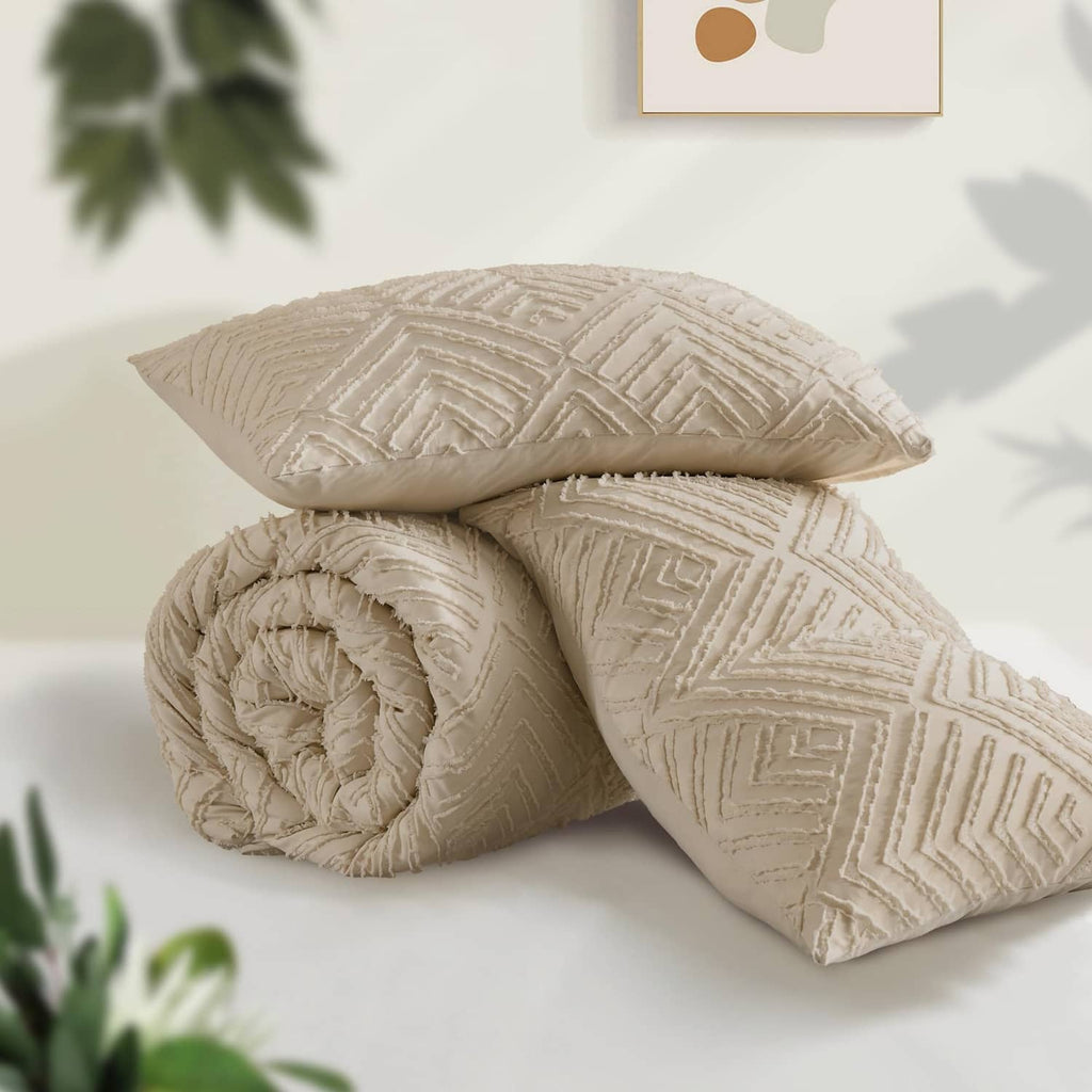 Folded light beige quilted comforter and decorative throw pillow with geometric texture