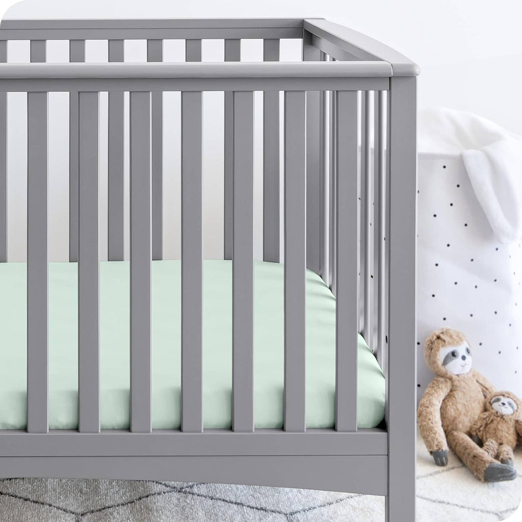 Mint fitted crib sheet on mattress with smooth surface and fitted edges