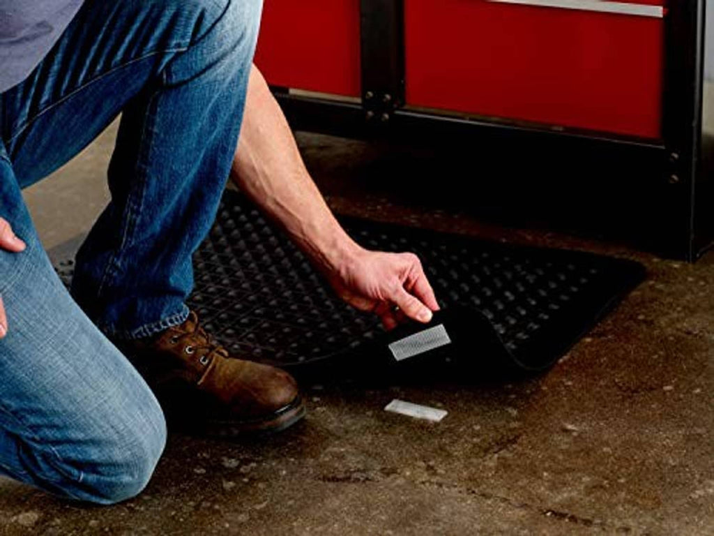 Black interlocking fastener strip being pressed onto a surface