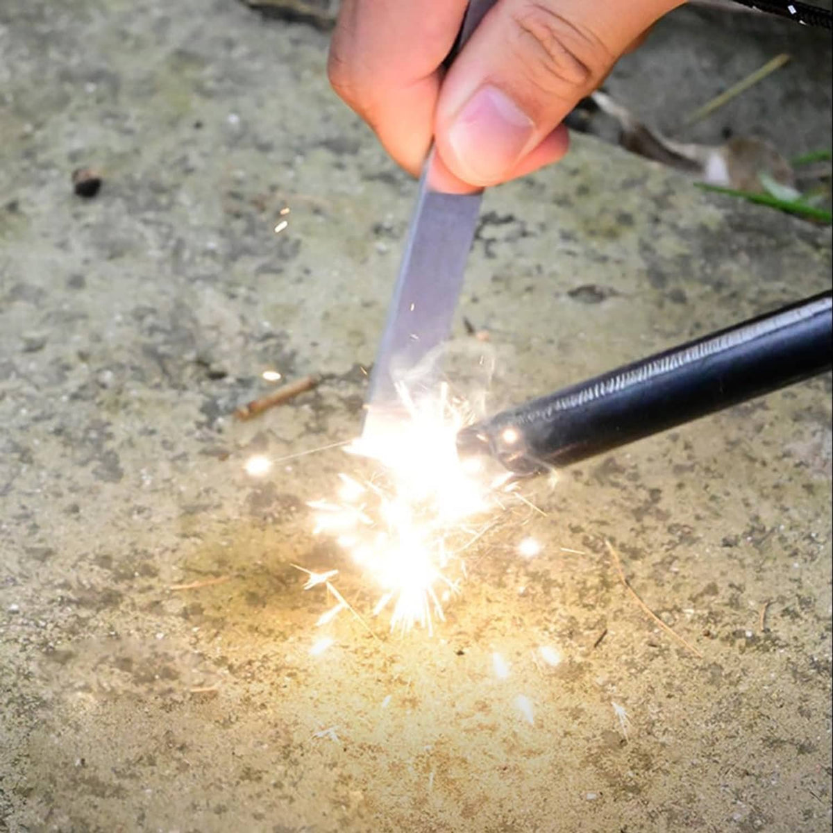 Fire starter striker tool creating sparks, silver high speed steel with serrated scraper edge