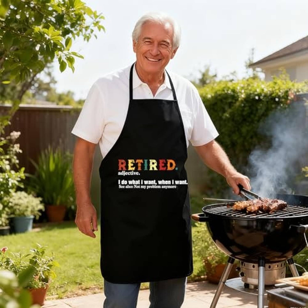 Black sleeveless apron with 'RETIRED' slogan on front worn by man near grill