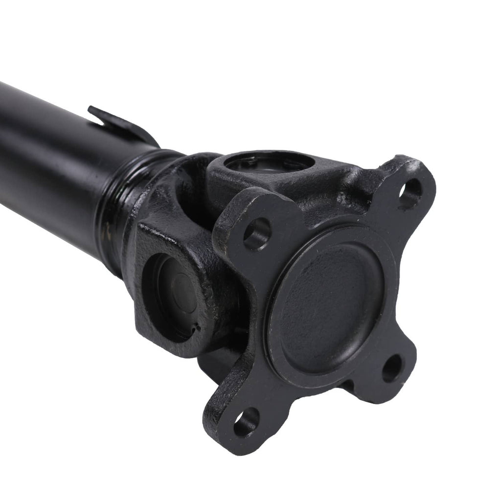 Front driveshaft prop shaft joint with black flange and round center cover, close-up