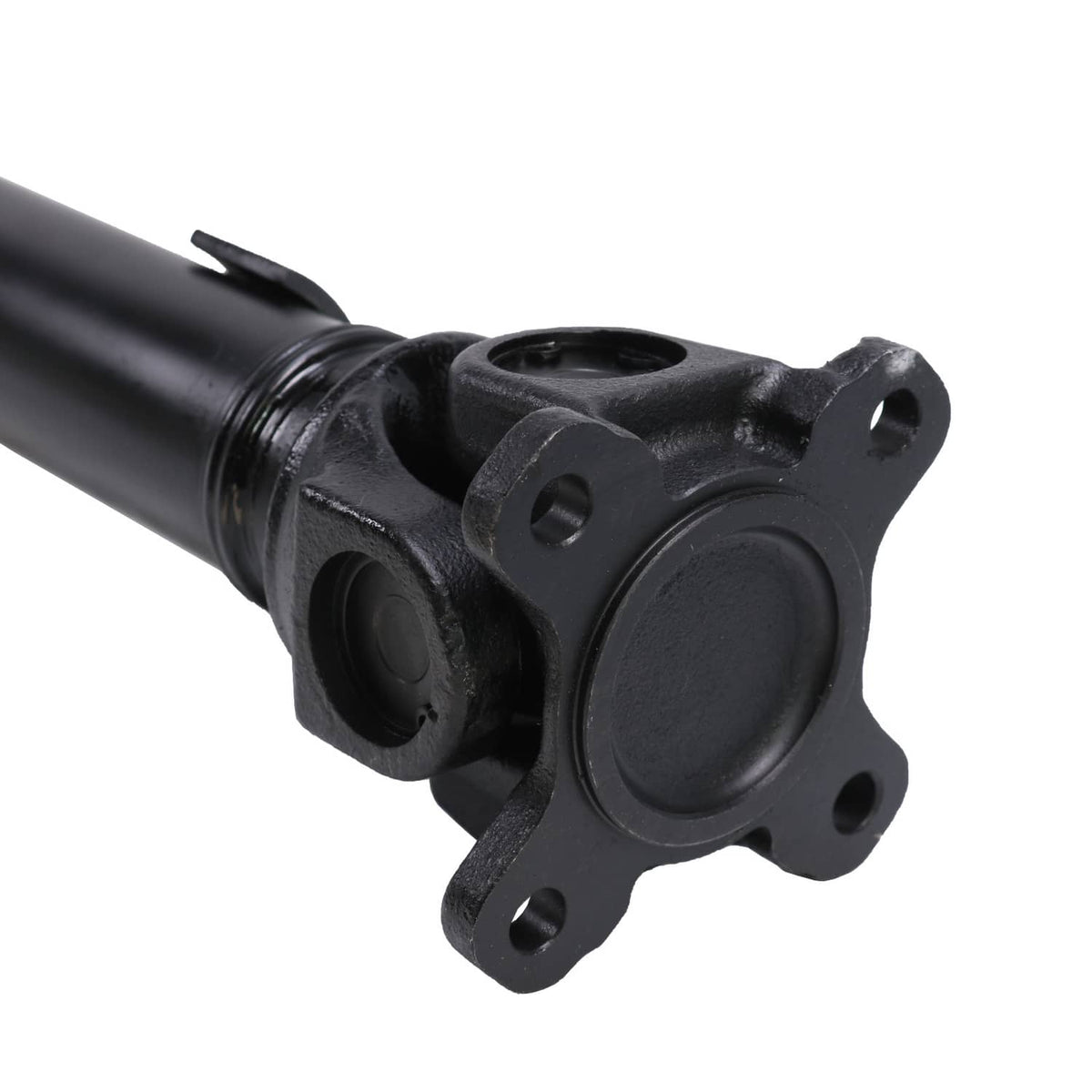 Front driveshaft prop shaft joint with black flange and round center cover, close-up