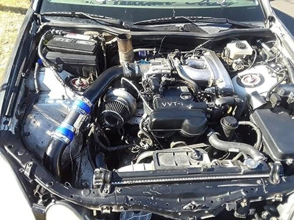 Engine bay view showing red silicone hose reducer coupler with blue clamps