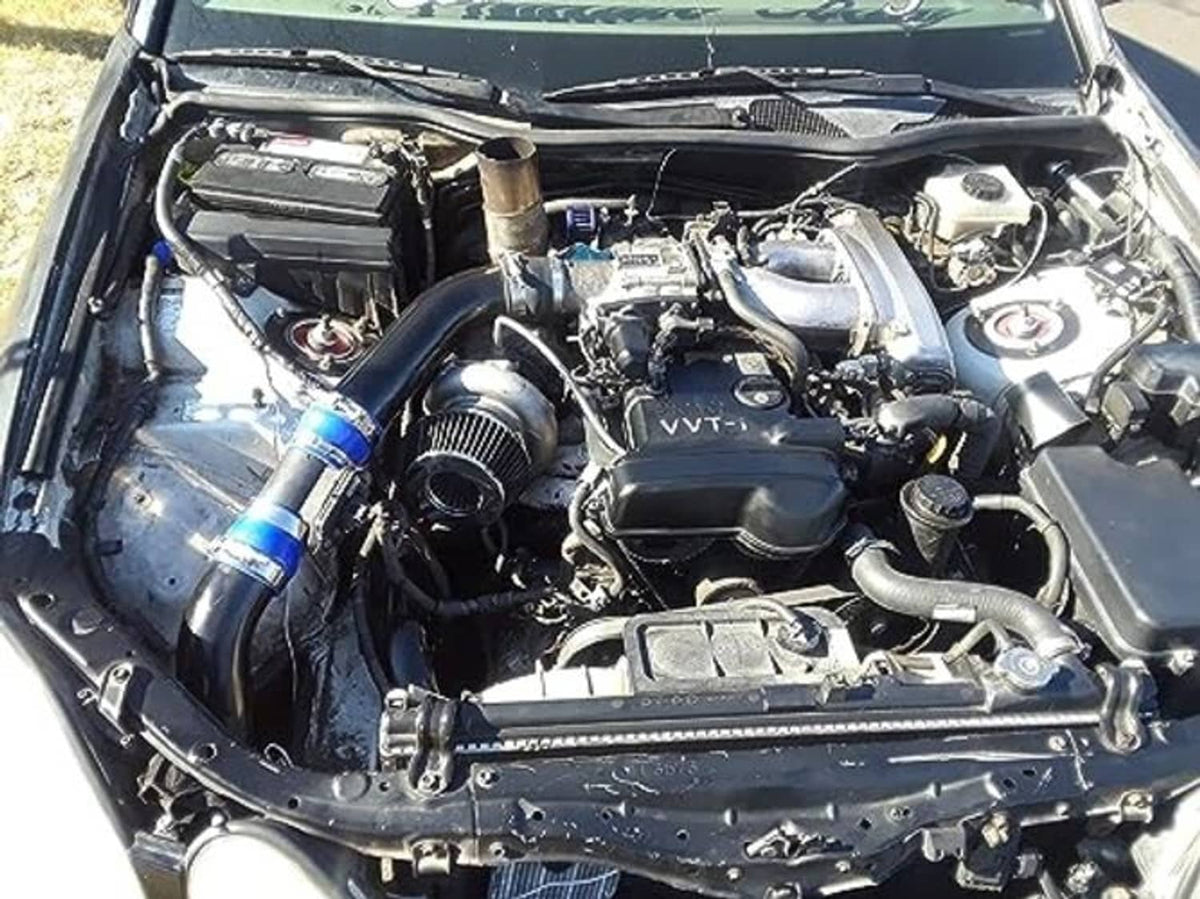 Engine bay view showing red silicone hose reducer coupler with blue clamps