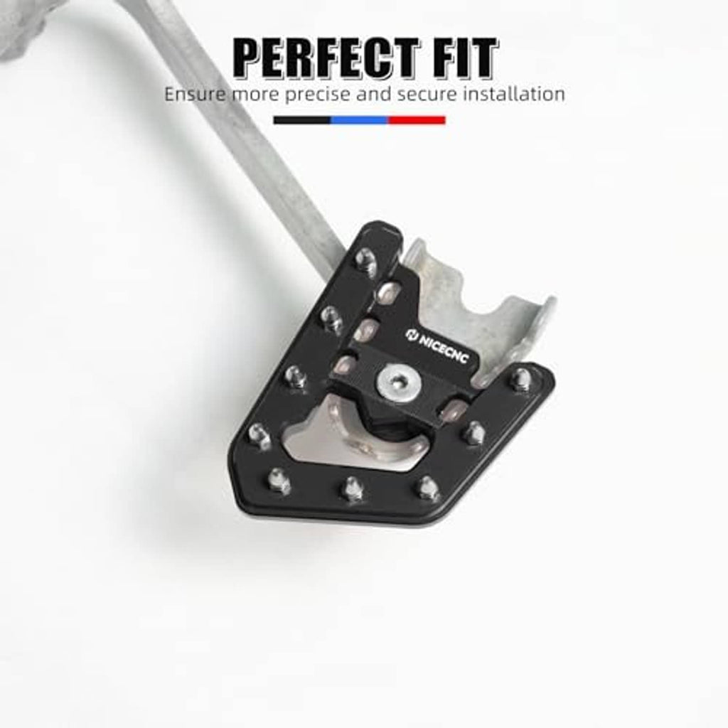 Black brake pedal lever extender with bolts on an open, stepped platform.