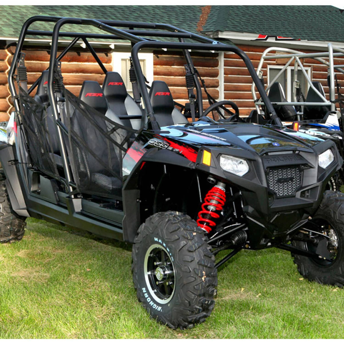 Red spring shock absorber mounted on a black UTV with tire visible