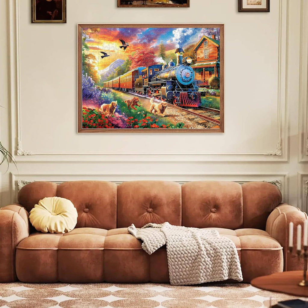 Framed completed jigsaw puzzle wall art with blue steam train and dogs in a garden