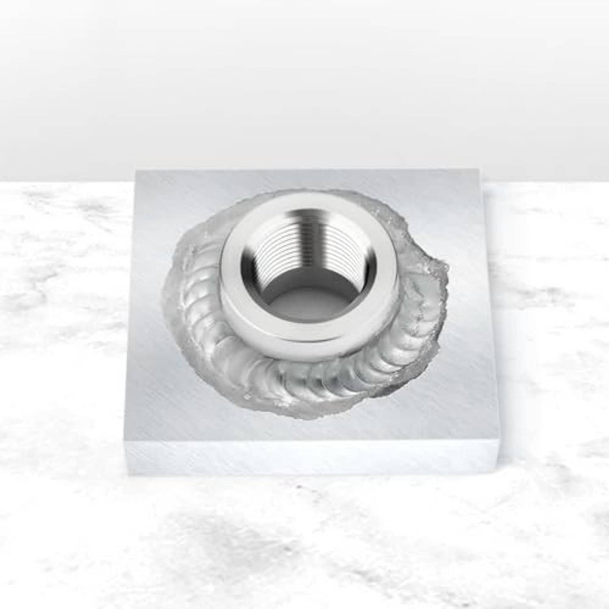 Aluminum weld-on bung with female 3/4" NPT threads welded onto metal plate