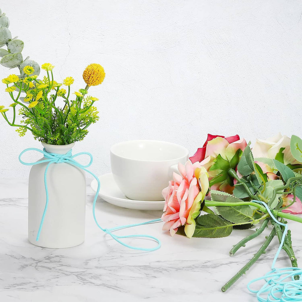 Faux suede leather cord tied around a floral bouquet and vase