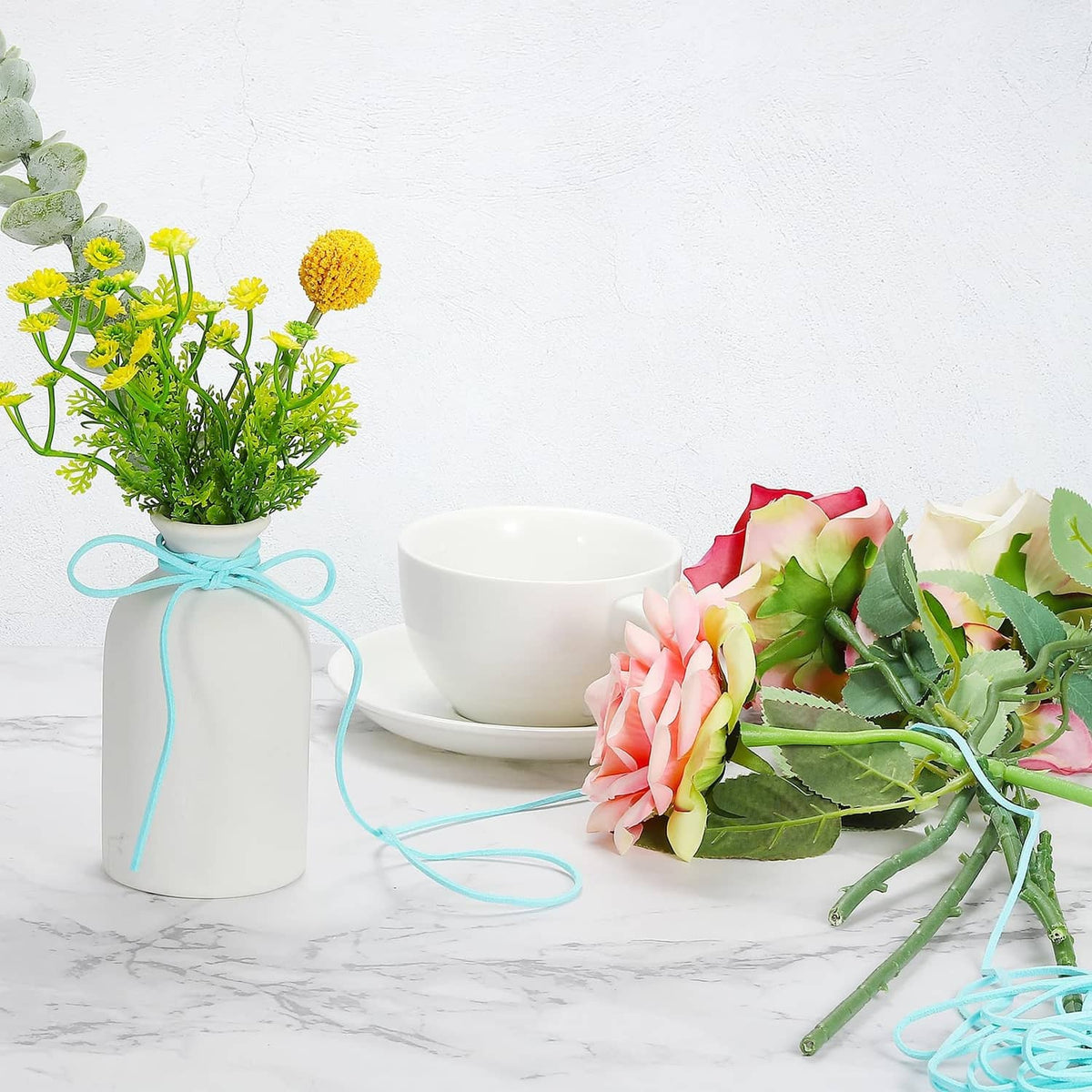 Faux suede leather cord tied around a floral bouquet and vase