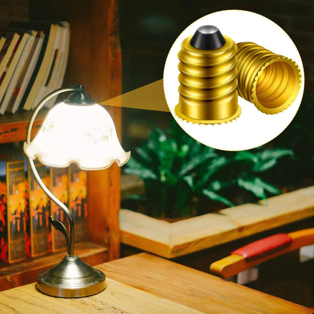 Gold E14 to E12 lamp adapter converter shown near a desk lamp base