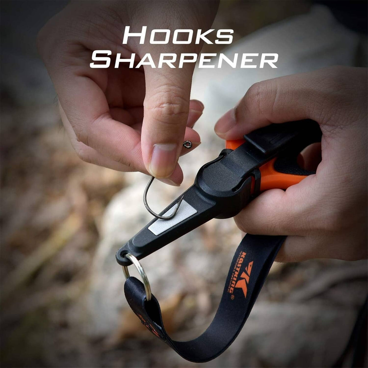Fishing hook sharpener on orange-and-black line scissors held near a metal hook