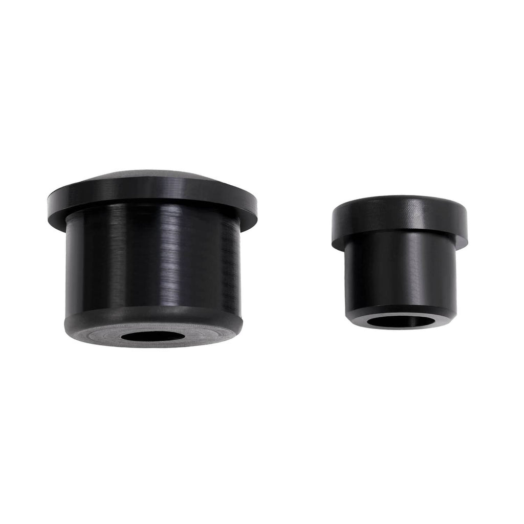 Pair of black rubber bushing components with center holes and cylindrical shape