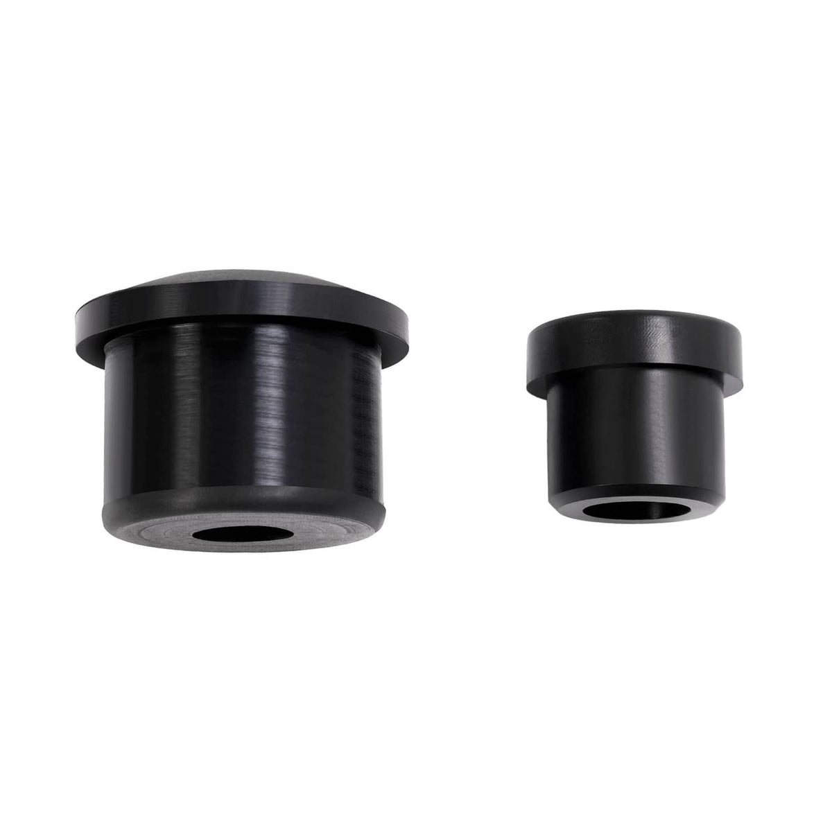 Pair of black rubber bushing components with center holes and cylindrical shape
