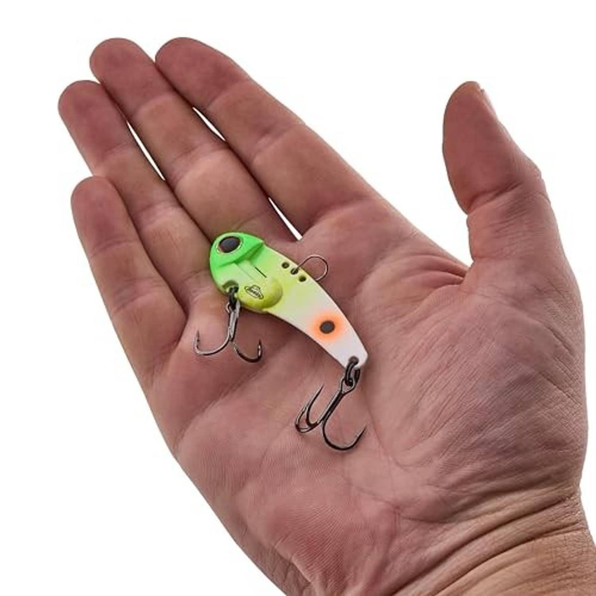Chartreuse blade fishing lure with orange eye, shown in a hand, two treble hooks