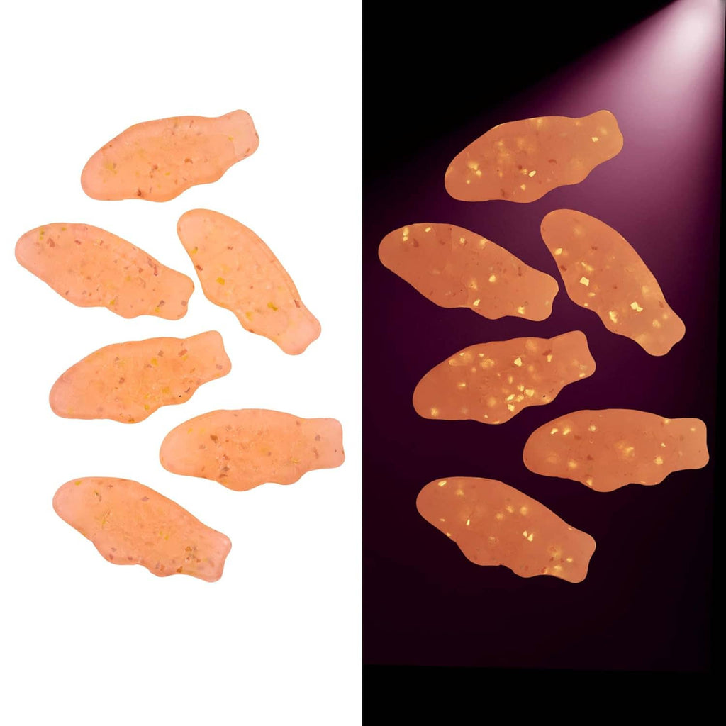 Soft & chewy gummy candy pieces, translucent orange-pink shapes with speckled look