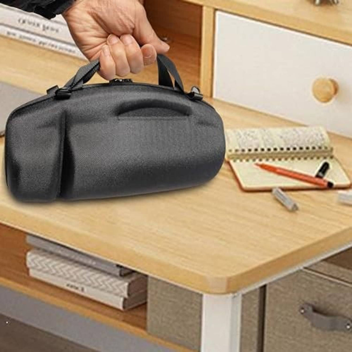 Black zip travel case with handle, shown being carried