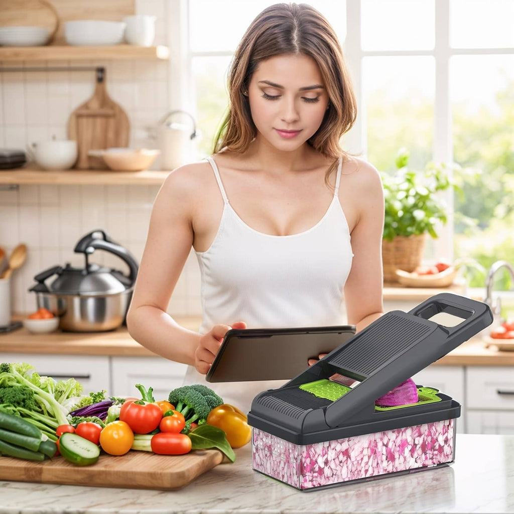 Vegetable chopper on countertop in use with green blade cartridge and clear container