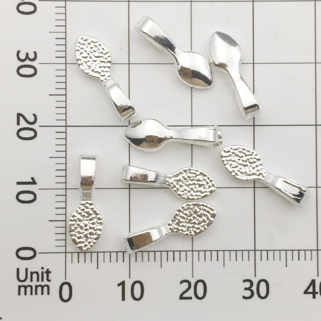 Shiny silver glue-on pendant bails next to a ruler for size reference