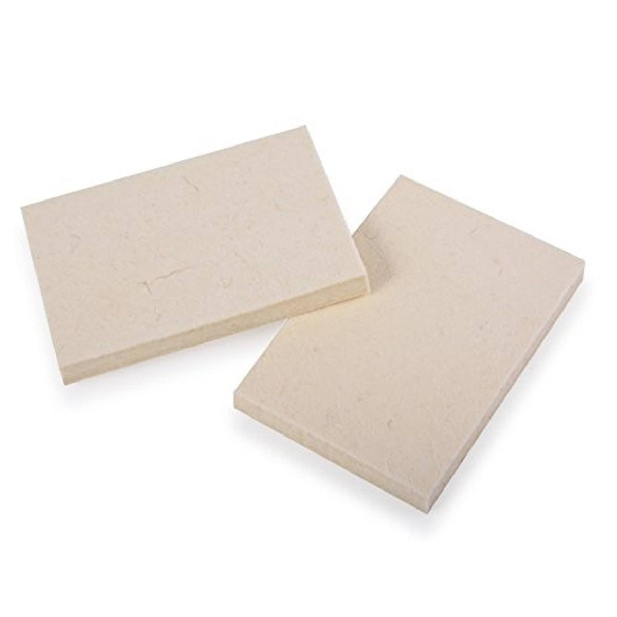 Two light beige rectangular felt squeegee pads angled on a flat surface