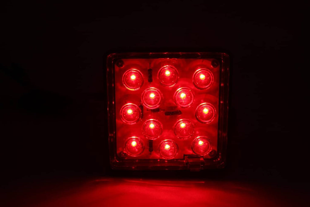 Red glowing square 12-LED hitch cover brake light with clear lens housing