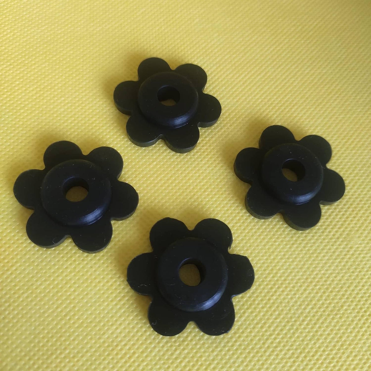 Black flower-shaped rubber garden flag stoppers with center hole, set of three