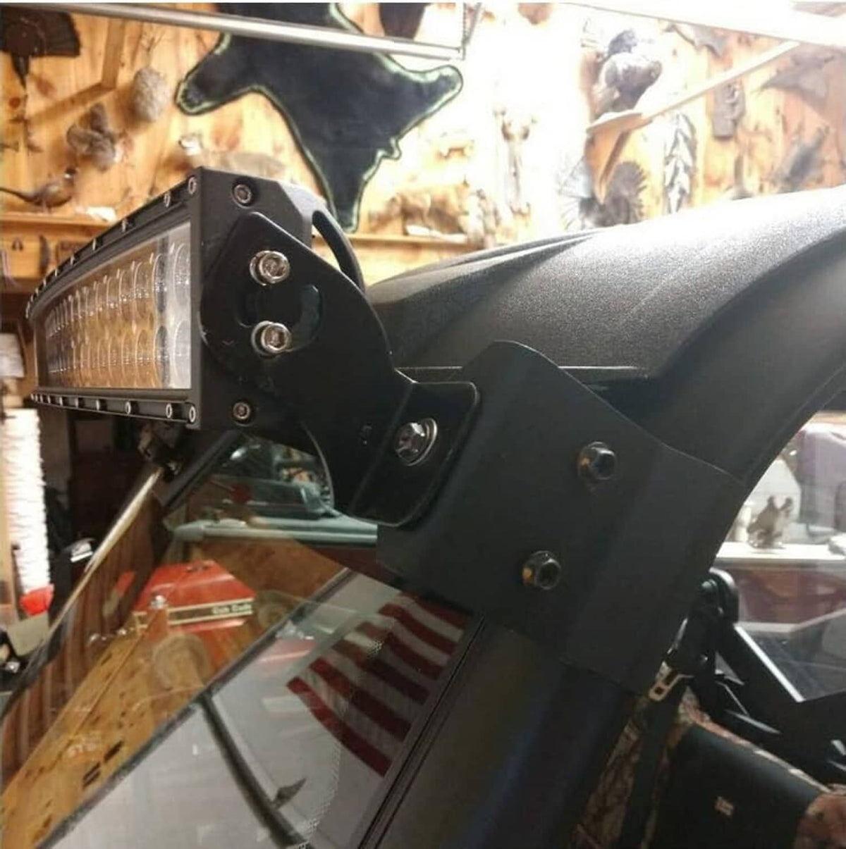 LED light bar mounting brackets installed on vehicle upper windshield area