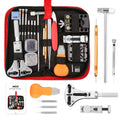 Watch repair tool kit with assorted tools in a black and red zip case