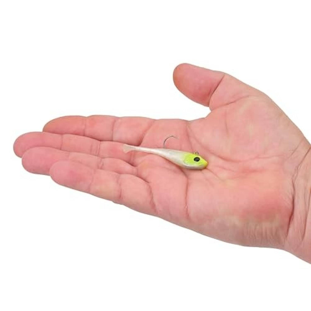 Soft plastic fishing bait in light green and white, held in open hand