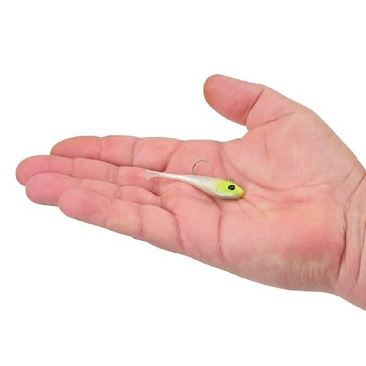 Soft plastic fishing bait in light green and white, held in open hand