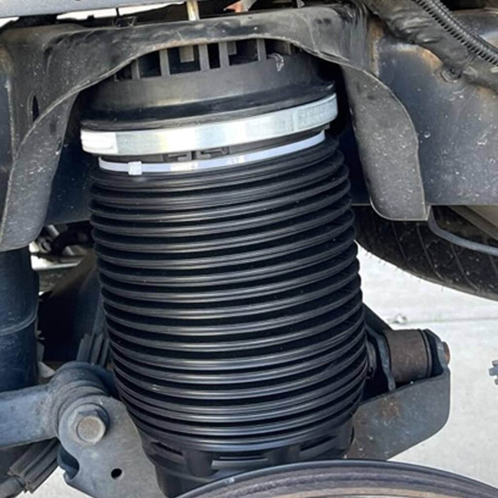 Black air suspension spring bag bellows with silver upper ring, close-up
