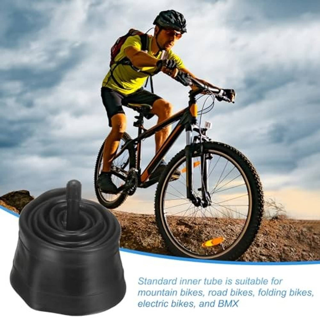 Black rubber bicycle inner tube with standard valve stem, shown near a bike wheel