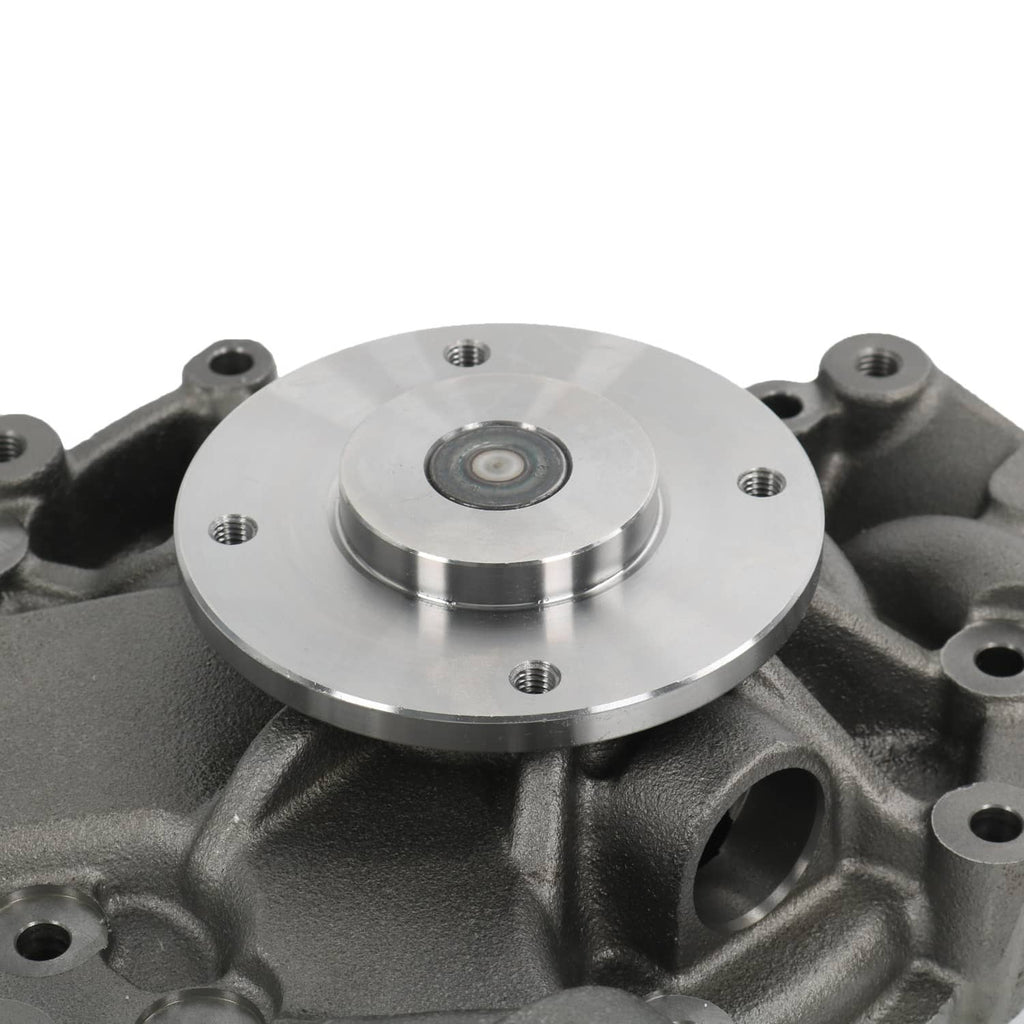 Water pump close-up showing circular plate with bolt holes and central fastener pin