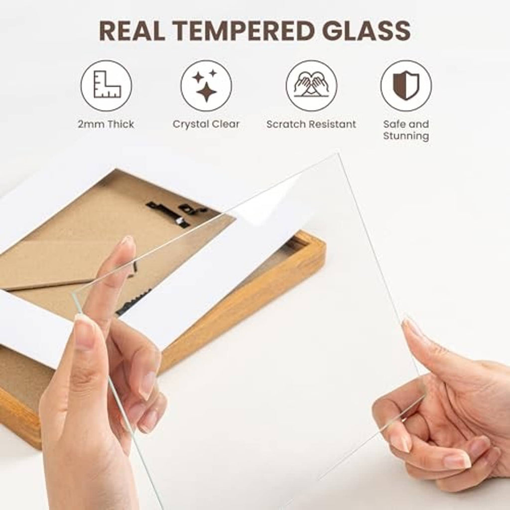 Walnut picture frame with tempered glass panel and hands installing the glass