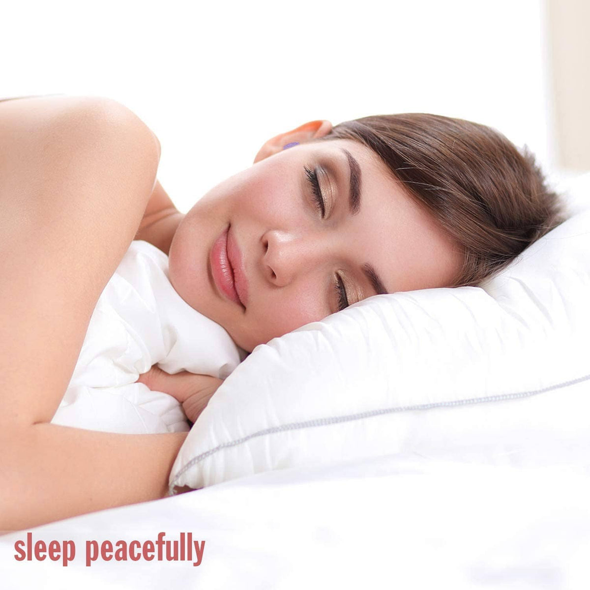 Purple soft foam earplug worn during sleep, earplug visible on pillow