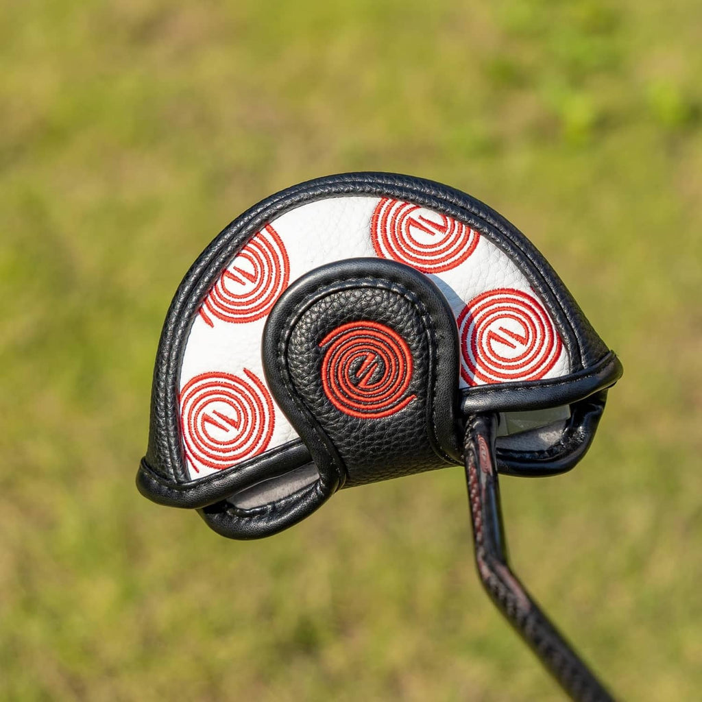 White-and-black putter headcover with red swirl pattern and black magnetic strap