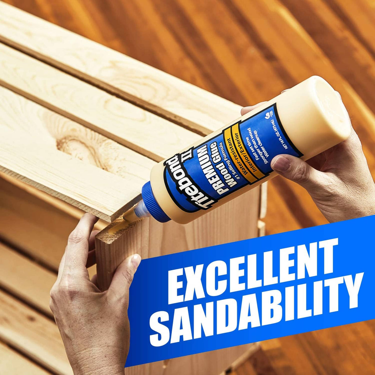 Hands squeeze Titebond II premium wood glue along wood boards for bonding