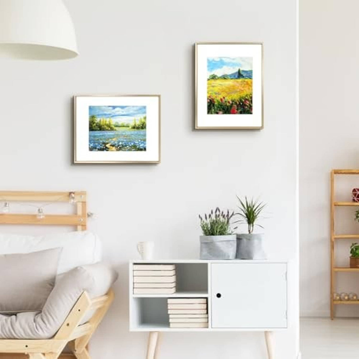 Two small gold picture frames with scenic landscape photos on display