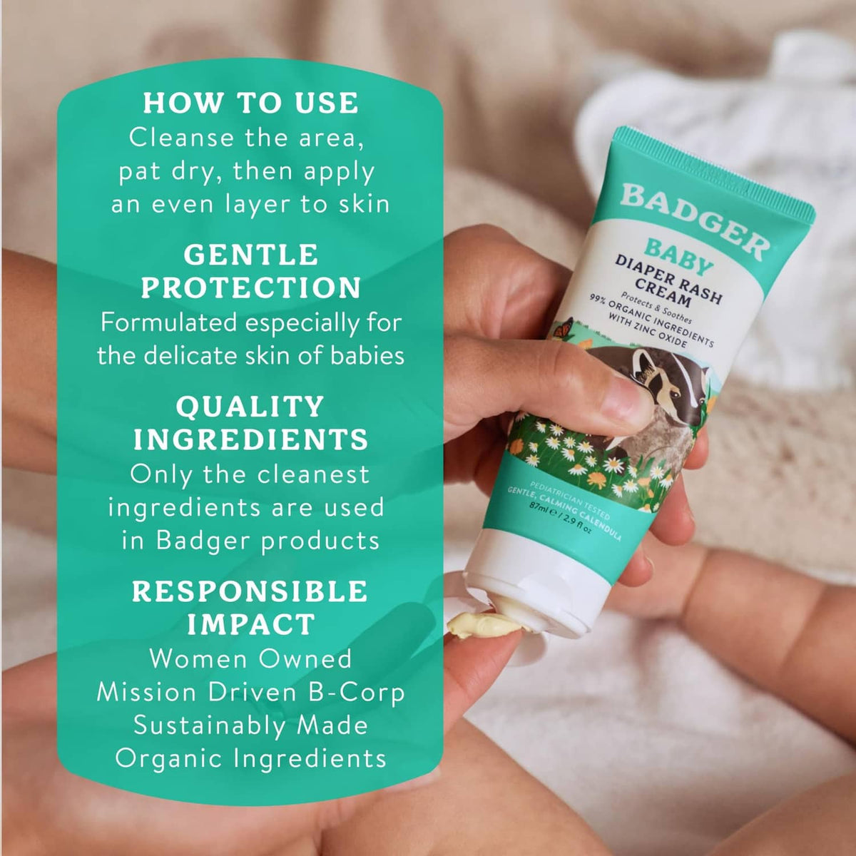 Hand holding BADGER Baby diaper rash cream tube, teal and white design