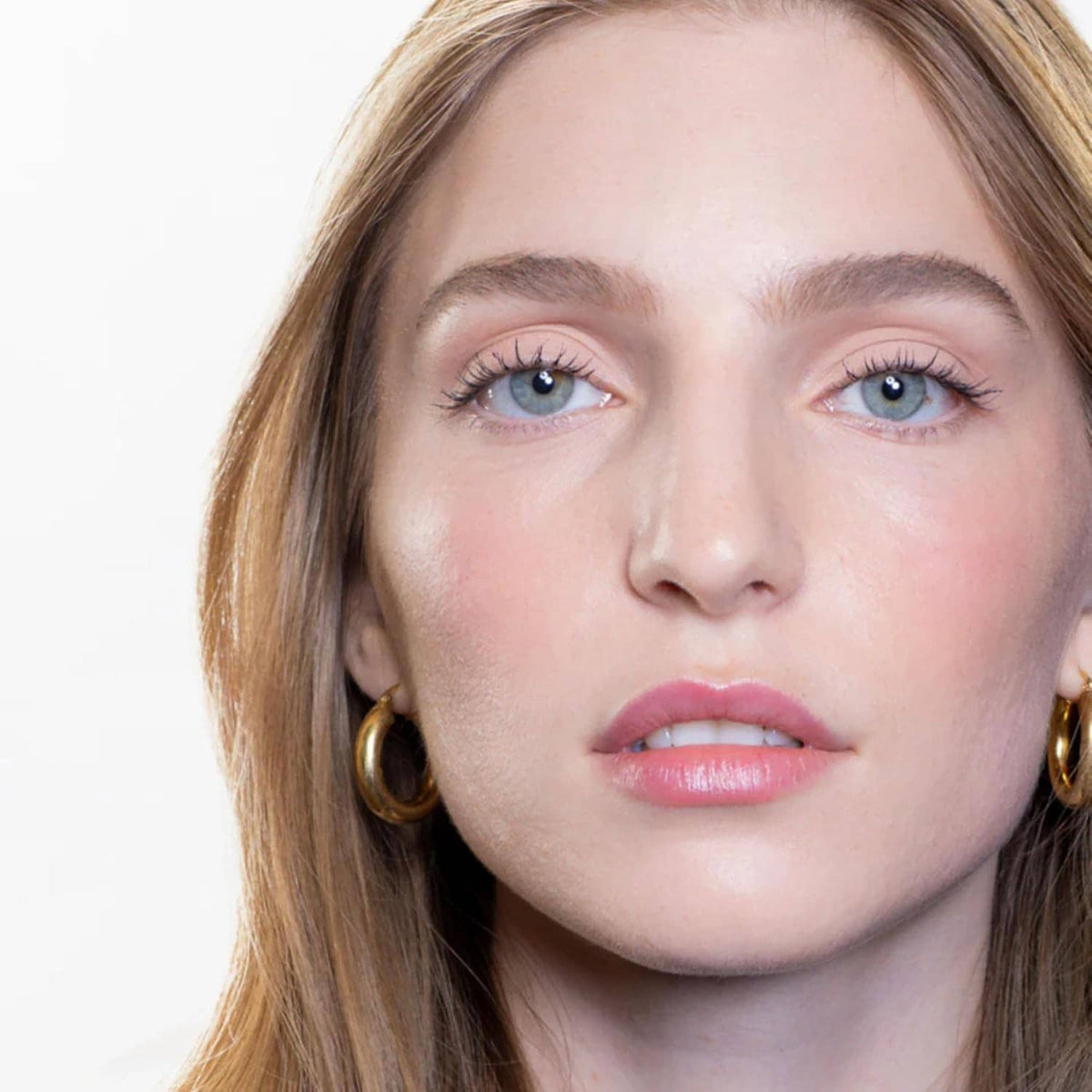 Close-up of woman’s eyes with rose-gold metallic eyeshadow blended on lids