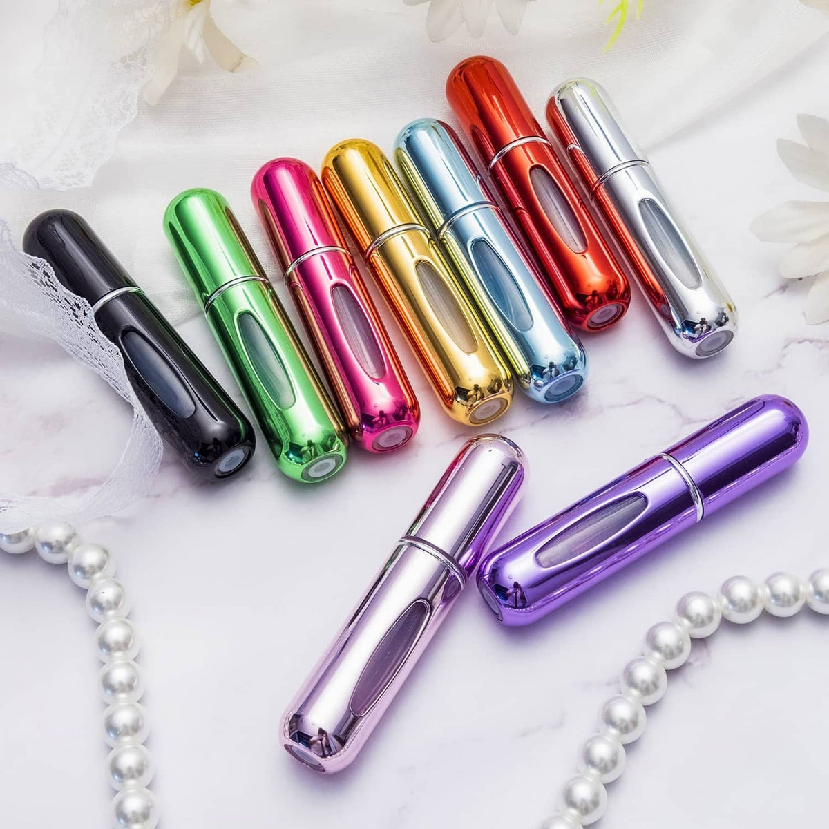 Assorted mini perfume atomizer bottles with metallic purple sprayer