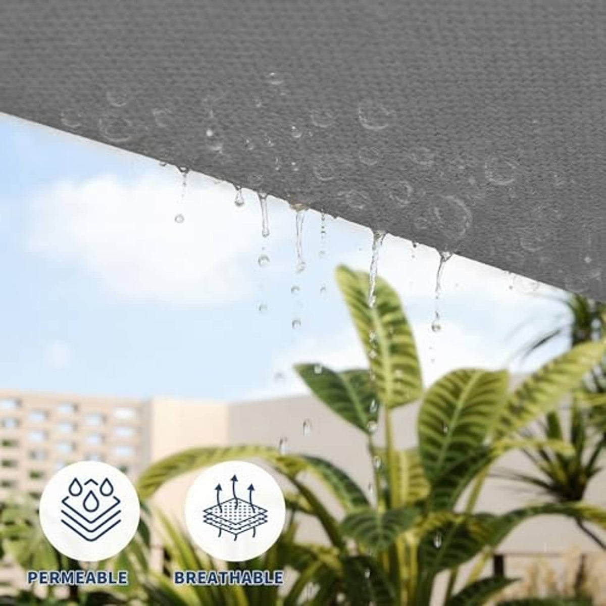 Dark grey shade sail underside with water droplets beading on fabric