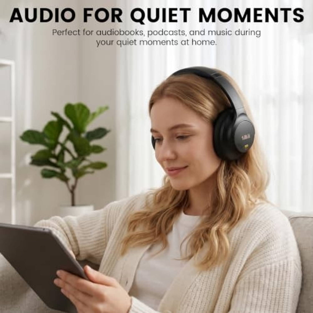 Black over-ear headphones worn by a person, cushioned ear cups and padded headband.